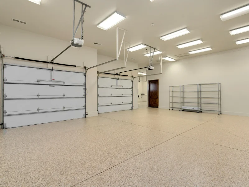 Clean residential garage interior with overhead garage doors
