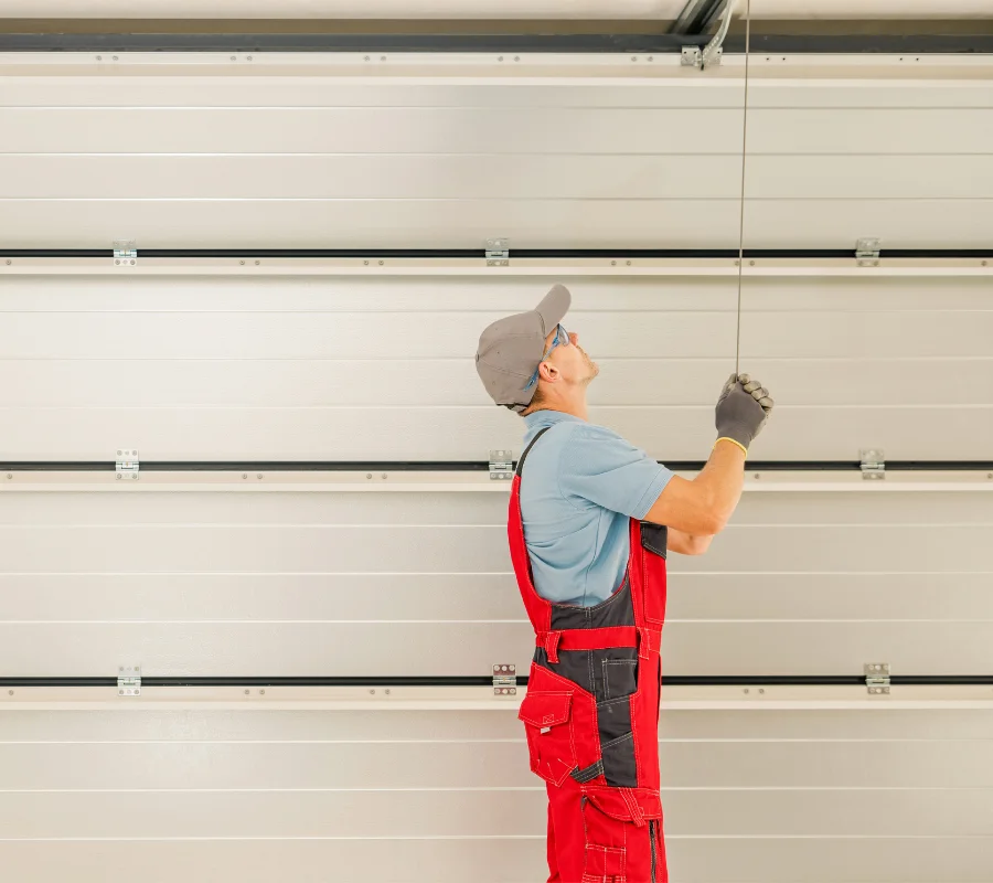 Garage door repair expert inspecting a residential garage door
