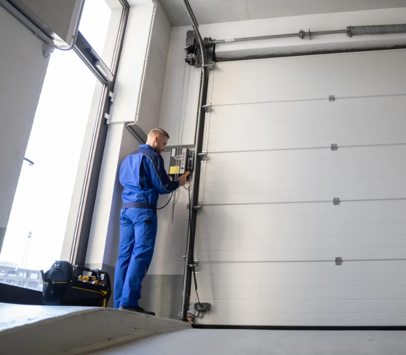 Technician installing a garage door opener system