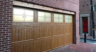 Wooden garage door with decorative window panels